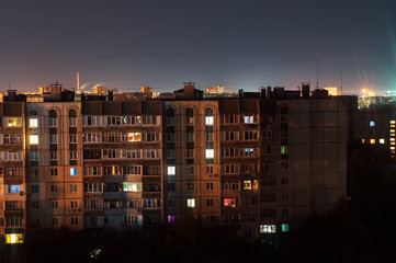 Night long exposure photo 9 and 10 floors high-rise buildings in orange colours. Big city life is here!