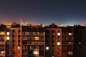 Night long exposure photo 9 and 10 floors high-rise buildings in orange colours. Big city life is here!