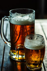 Big and small cups of beer