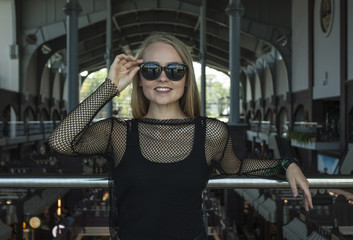 Sunglasses. Street fashion concept - close up portrait of a pretty blonde girl.