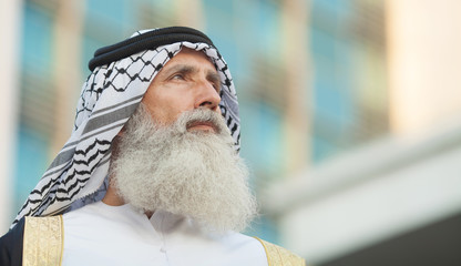 Senior Arabic man in traditional clothes outdoor portrait