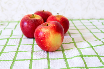 red apples on a checkered tablecloth detail