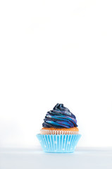 Cupcake with galaxy whipped cream on white background