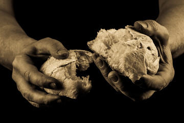 Helping hand sharing a piece of bread. Man giving Bread, Helping Hand Concept. Aged Photo Amber