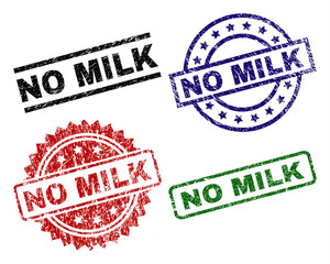 NO MILK seal imprints with corroded style. Black, green,red,blue vector rubber prints of NO MILK title with scratched style. Rubber seals with round, rectangle, medallion shapes.