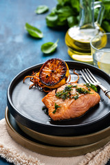 Salmon Sole Meuniere with lemon. Fillet of red fish. Steak trout fried with butter, lemon and parsley sauce