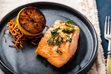 Salmon Sole Meuniere with lemon. Fillet of red fish. Steak trout fried with butter, lemon and parsley sauce