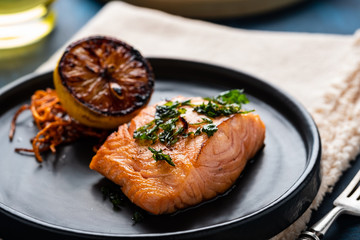 Salmon Sole Meuniere with lemon. Fillet of red fish. Steak trout fried with butter, lemon and parsley sauce