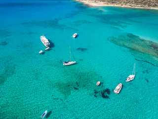 Fototapeta na wymiar A unique beach in the protected area of Balos Beach with yachts and boats. Aerial view from drone. Crete. Greece.