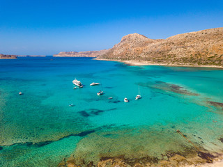 A unique beach in the protected area of Balos Beach with yachts and boats. Aerial view from drone. Crete. Greece.