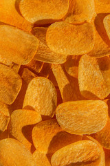Handful of yellow potato chips