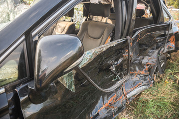 crashed doors of off-road car after the accident are on the sidelines