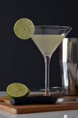 Glass of daiquiri cocktail on wooden chopping board