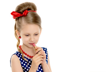 Little girl makes herself a make-up.