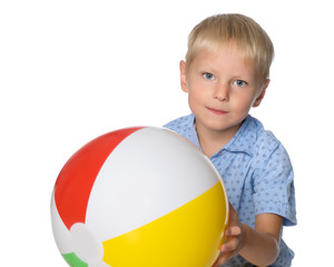 A little boy is playing with a ball.