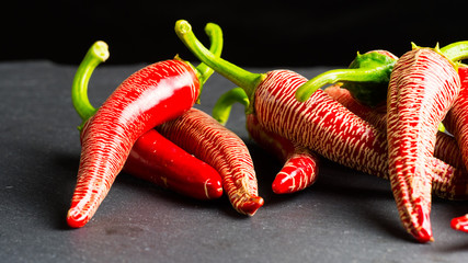 Red chilis on grey background © naturenow