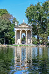 Rome Italy. Garden of Villa Borghese. Lake with boats and temple of Aesculapius,  (tempio di Esculapio)