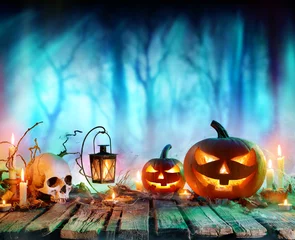 Küchenrückwand glas motiv Jack O' Lanterns And Candles On Table In Misty Forest - Halloween Background   © Romolo Tavani
