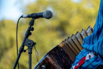 Close up of accordion player playing at Klezmer Jewish music concert in Regent's Park in London UK