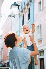 Naklejka premium Mother with baby in historical old town of Piran, Slovenia