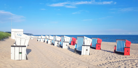Fototapeta na wymiar Sandy beach and beach chairs on Baltic Sea