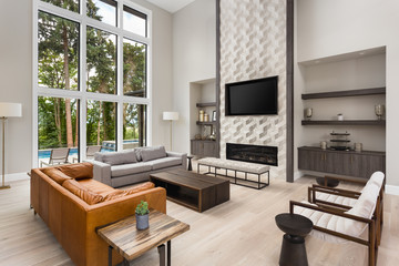 Beautiful living room interior in new luxury home with open concept floor plan. Features hardwood...