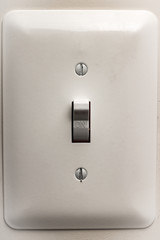 White Wall Mounted Light Switch In On Position