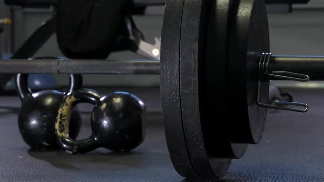 Dark moody 4k Footage of metal weights at home garage gym
