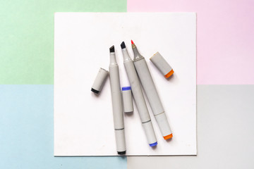 top view of color painting markers on the office creative art layout concept with soft colours d