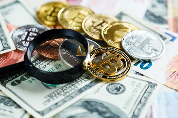  Bitcoins through magnifying glass on the real money background. Investment, risk, business strategy