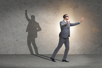 Businessman and his shadow in business concept