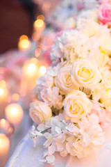 Obraz na płótnie Canvas flower arrangement, crystal, glass candles decorate banquet hall