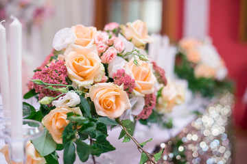 flower arrangement, crystal, glass candles decorate banquet hall