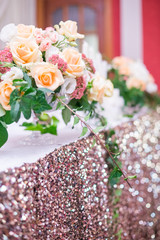 flower arrangement, crystal, glass candles decorate banquet hall