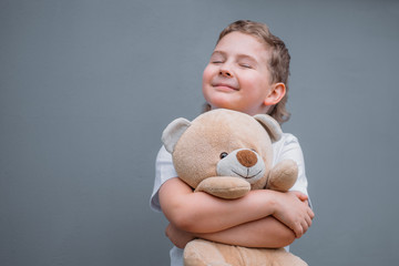 Safety concept. The boy is holding teddy bear
