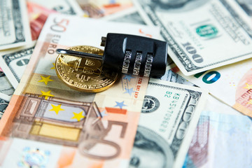 lock on  bitcoins on real money background. Internet  security, risk, investment, business concept
