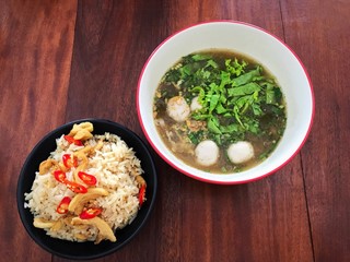 Thai beef soup and rice and shrimp wonton on wooden table background