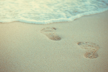 Close up of human footprints on the sand beach, Selective focus.