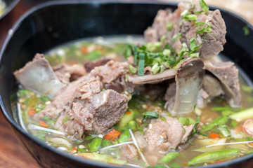 Hot and spicy pork spare rib soup with tamarind and Thai herbs in bowl, Tom yum, Hot and sour soup.
