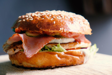 Side View of Mouth-watering delicious craft burger on the wooden table