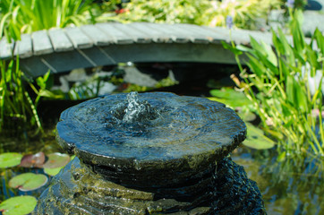 Bubbling decorative fountain in pond