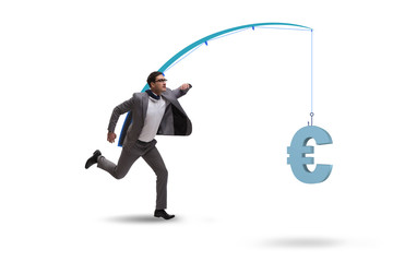 Businessman chasing money on fishing rod