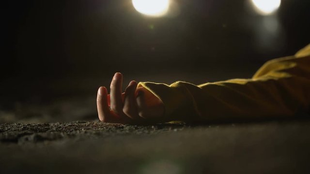 Unconscious victim lying on road, automobile driving after road accident, crime