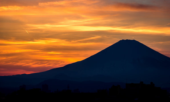 Golden sunset behind the silhouette of mount Fuji