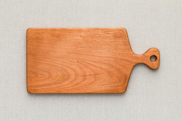 Cherry wood cutting board on linen, handmade wood cutting board