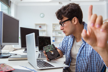 Technician with broken hard drive