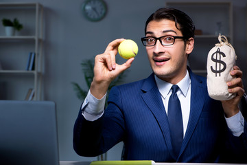 Young employee with tennis ball