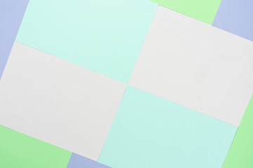 Table top view aerial image of colorful pastel paper background concept.Abstract  flat lay pink blue purple and green wallpaper.
