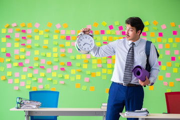 Sportive man in the office with many conflicting priorities in t