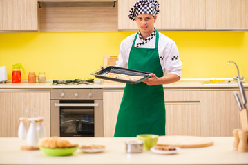 Young man cook preparing cake in kitchen at home 